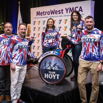 Members of the Hoyt Family pose with Rick Hoyt's wheelchair