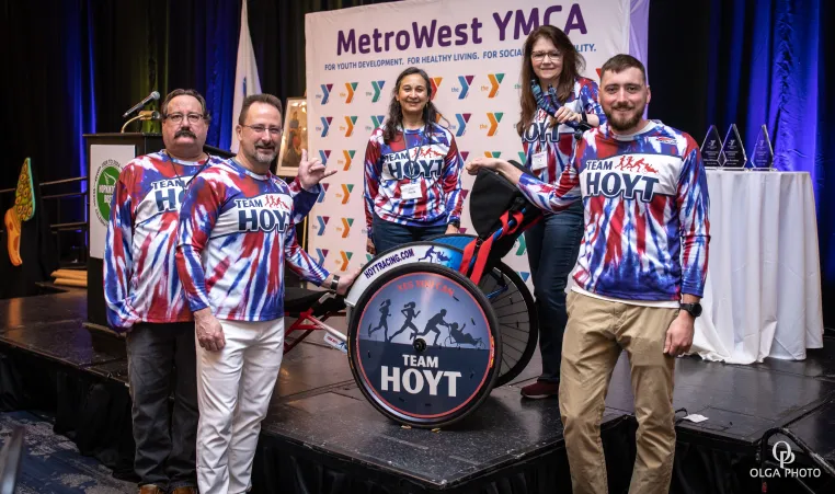 Members of the Hoyt Family pose with Rick Hoyt's wheelchair