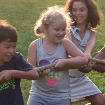 young campers play tug of war