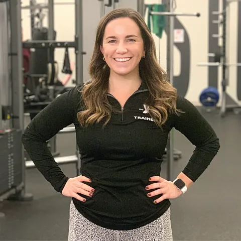 female personal trainer smiling at the camera
