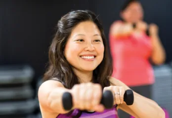 woman exercising with dumbbells