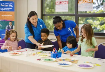 Y staff members helping youth in afterschool program