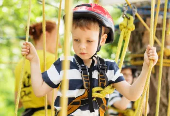 close up image of young boy on the ropes course