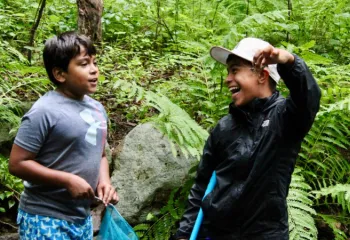 image of two boys with one proudly holding up a crayfish