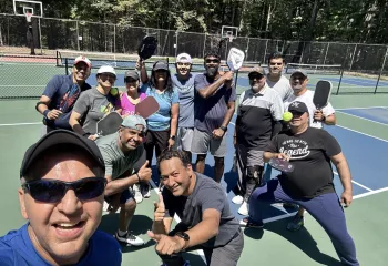 Men and women goofing around at a pickleball clinic