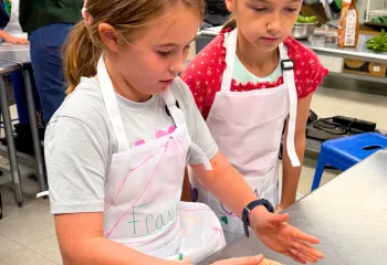 Children in the teaching kitchen baking