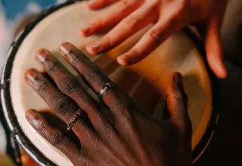 2 hands hitting an African Drum
