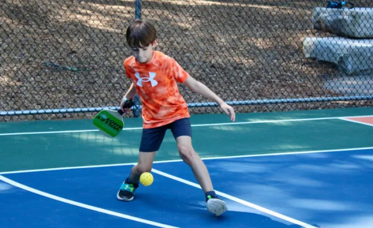 boy playing pickleball