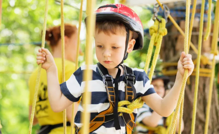 close up image of young boy on the ropes course