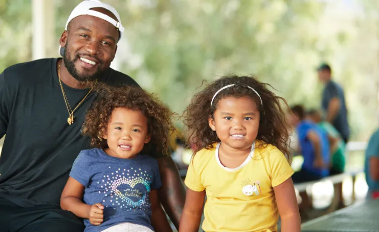 image of a dad with two young girls