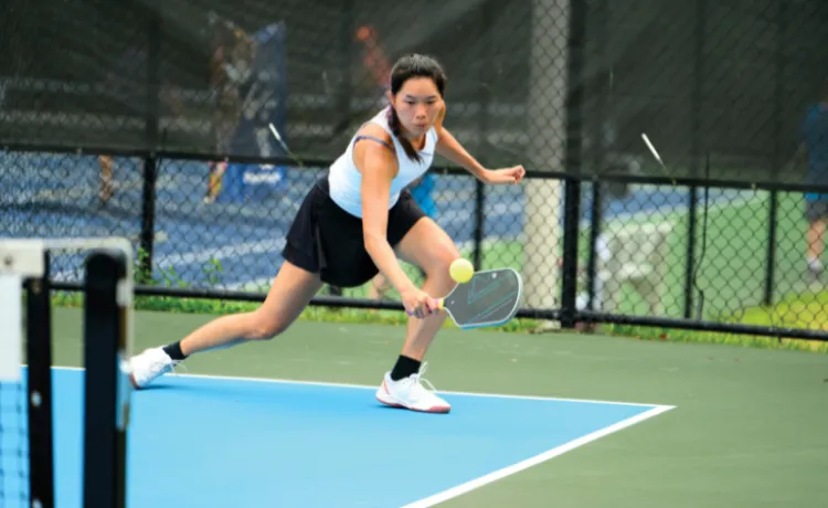 image of a woman playing pickleball