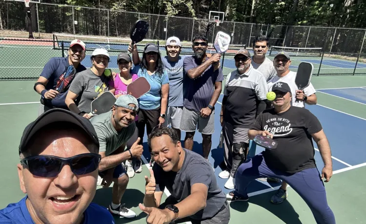 Men and women goofing around at a pickleball clinic