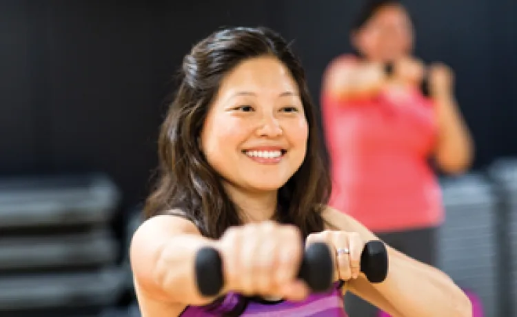 woman exercising with dumbbells