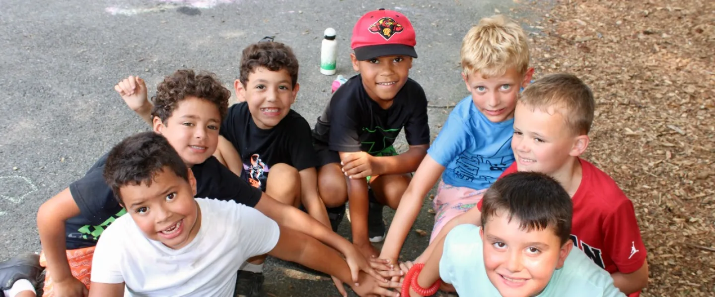 group photo of young boys outside at camp