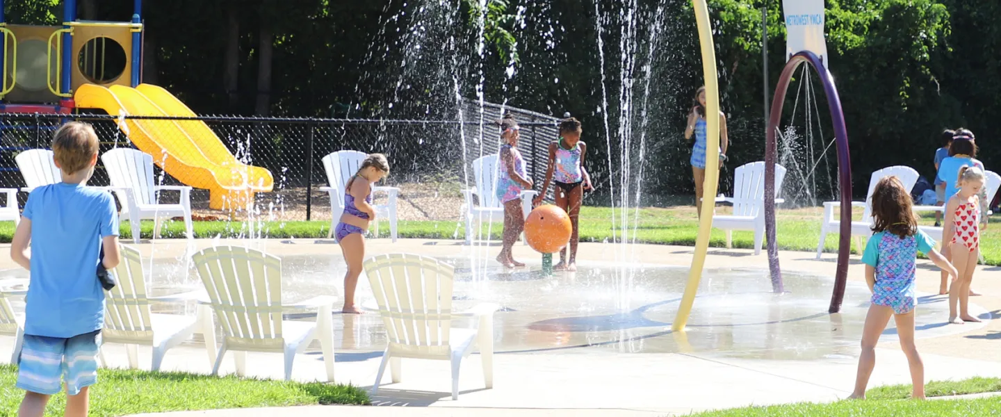 image of kids playing outside in the splash pad