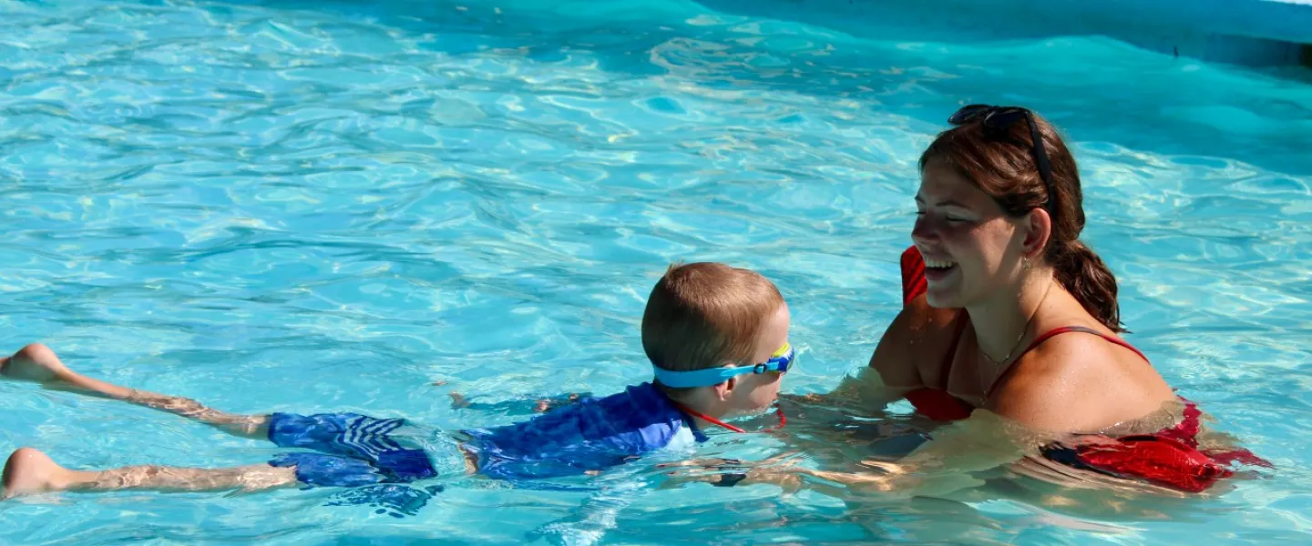 Instructor teaches a swim lesson in a YMCA pool