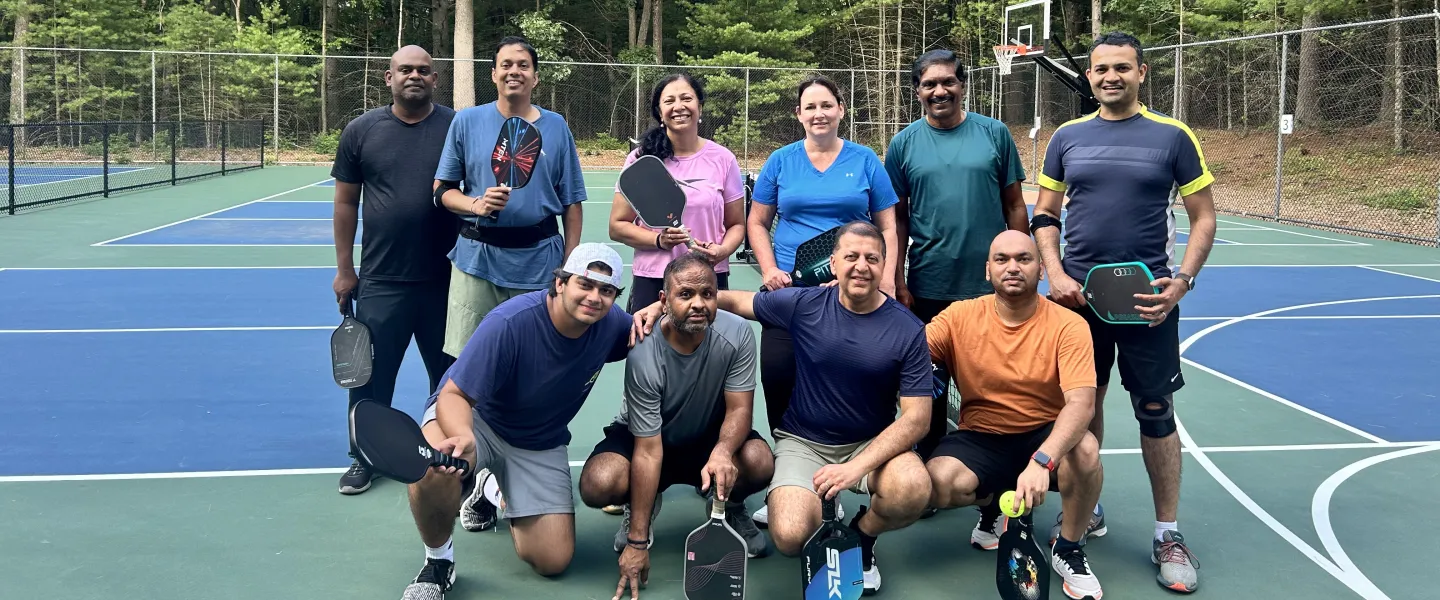 neighbors play pickleball on our outdoor courts
