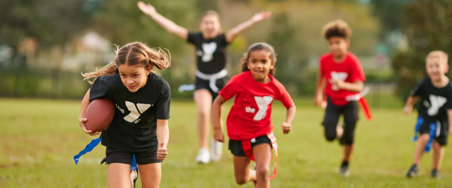 School aged children active playing outdoor football