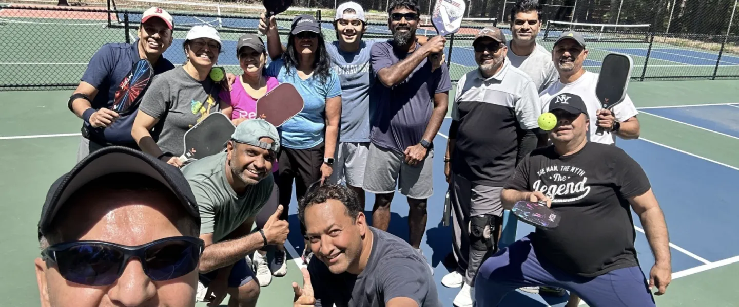 Men and women goofing around at a pickleball clinic