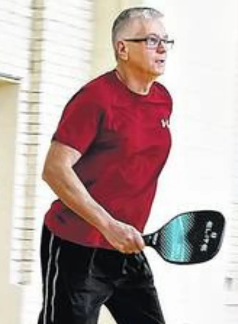 adult men playing indoor pickleball
