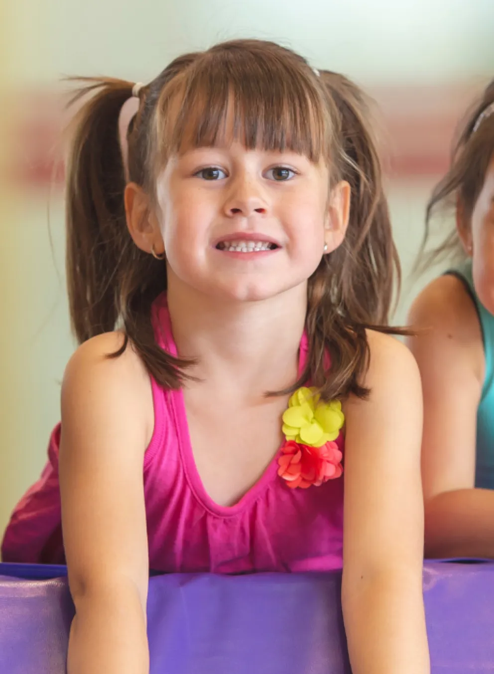 three young kids smiling on obstacle course