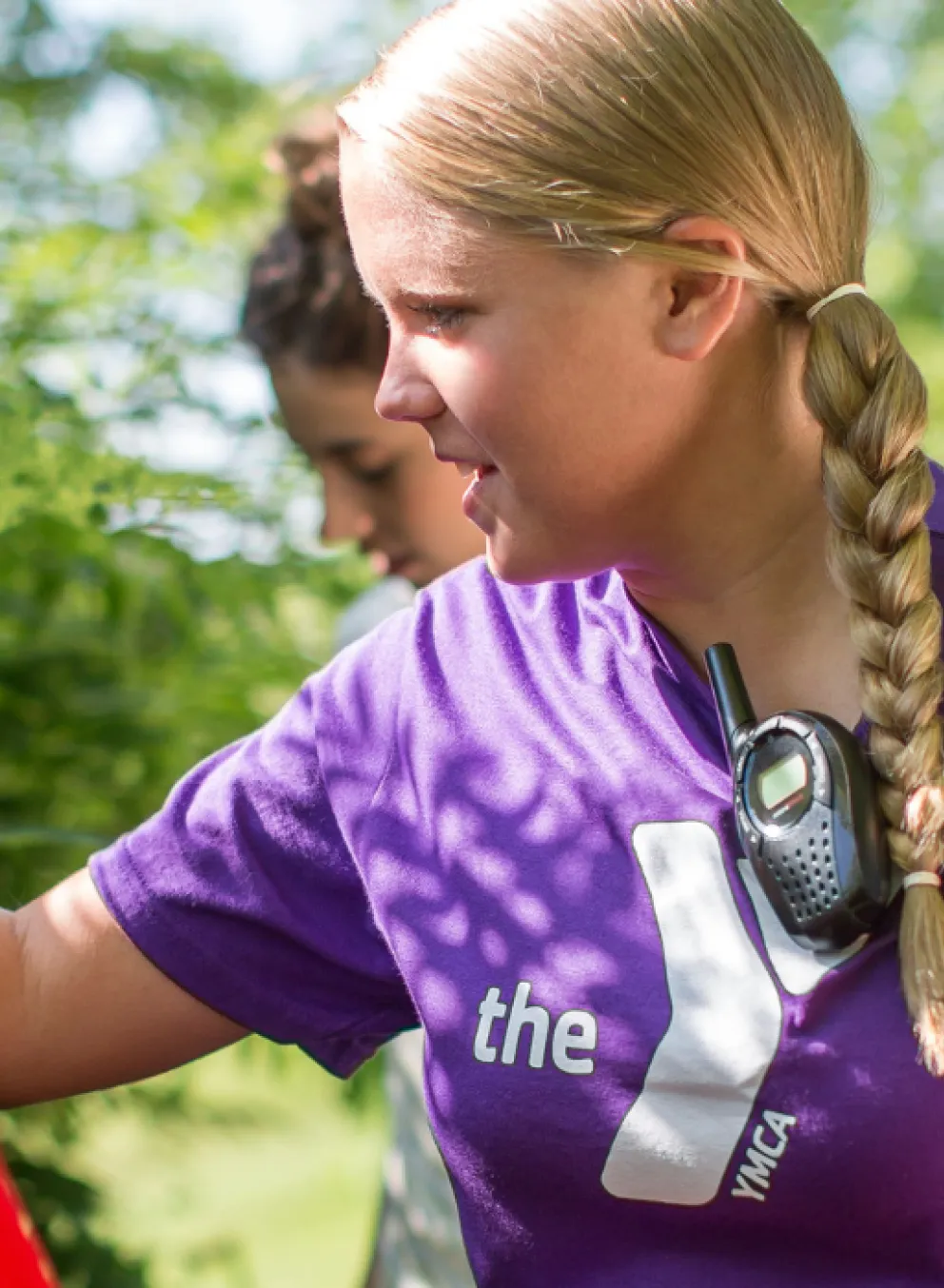female y staff member showing kids different plants