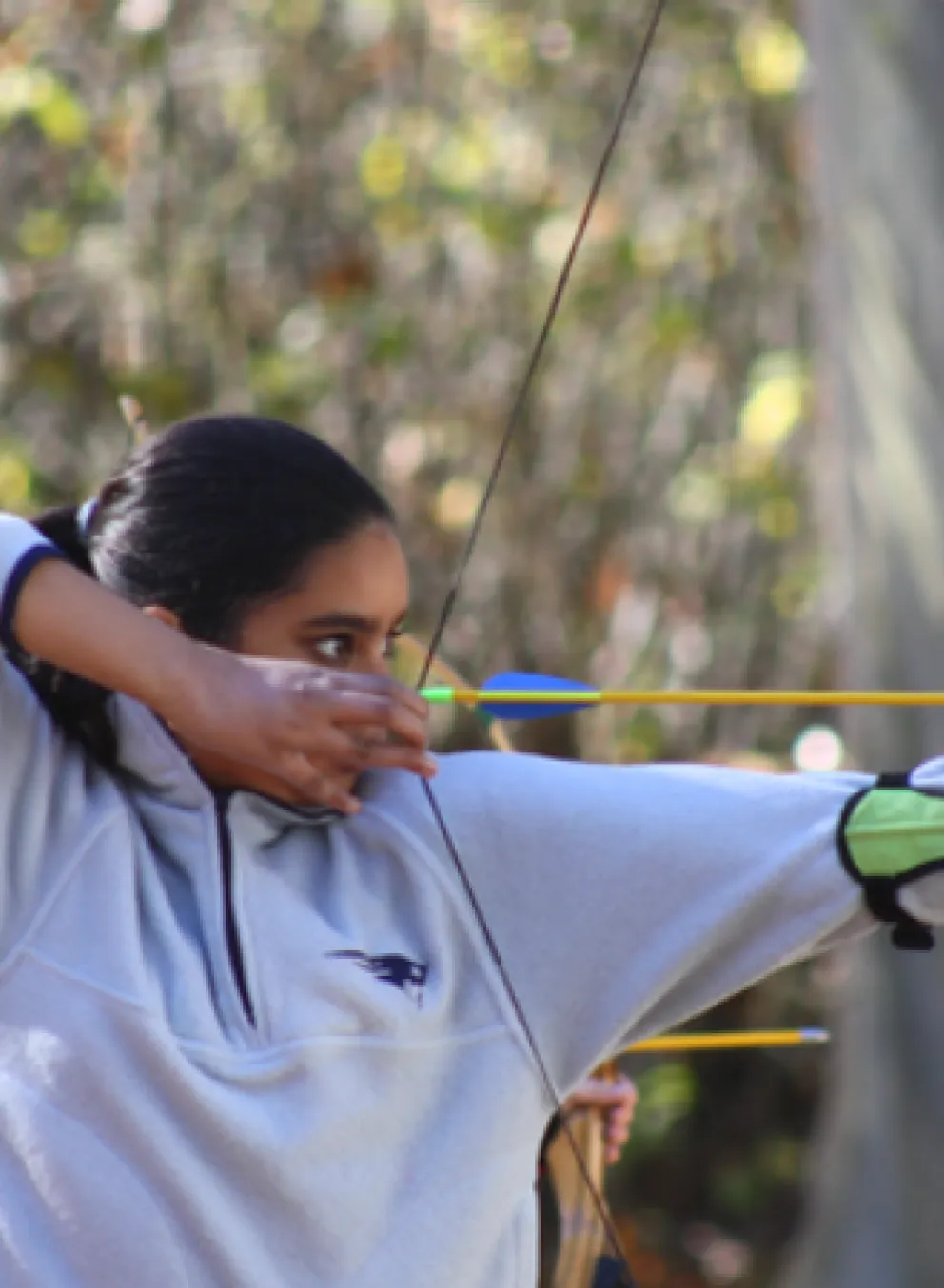 photo of a girl holding bow and arrow