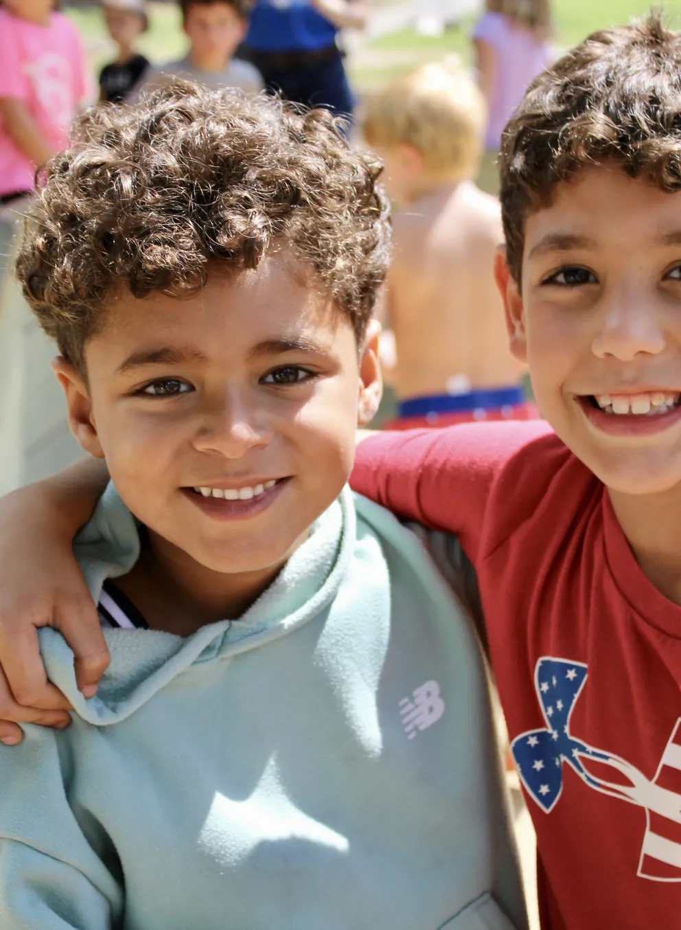 Smiling boys make friends at camp