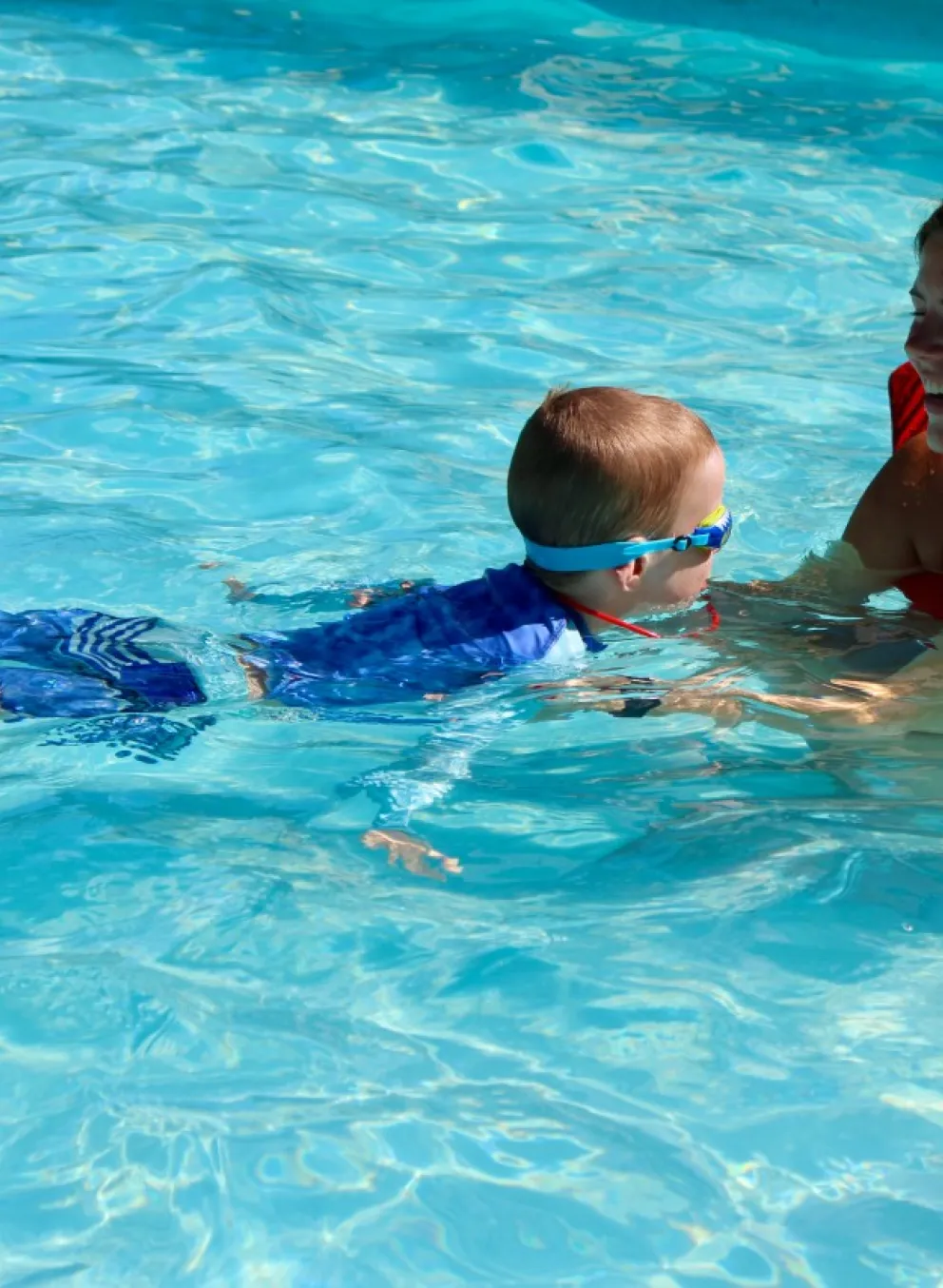 Instructor teaches a swim lesson in a YMCA pool