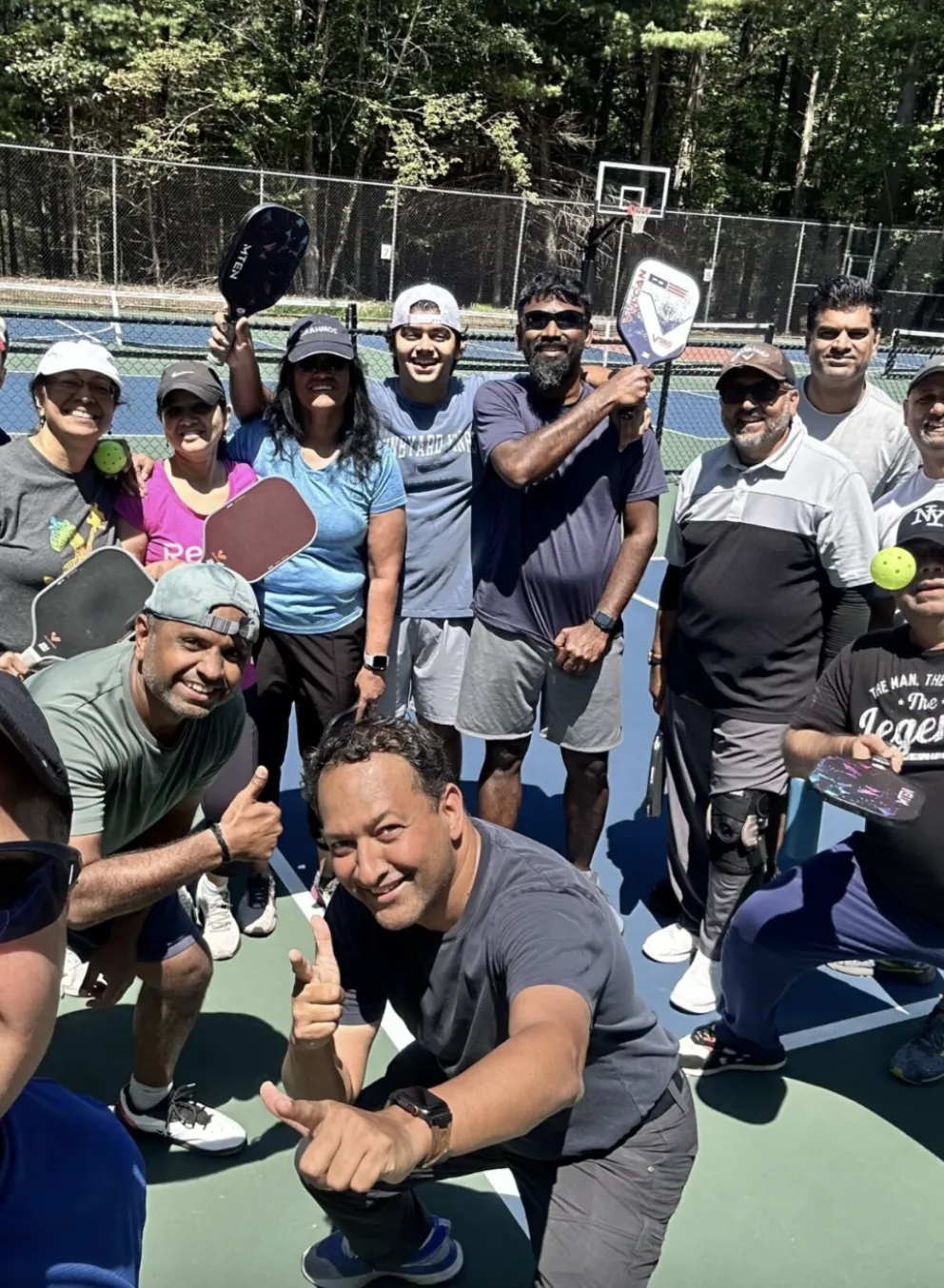 Men and women goofing around at a pickleball clinic
