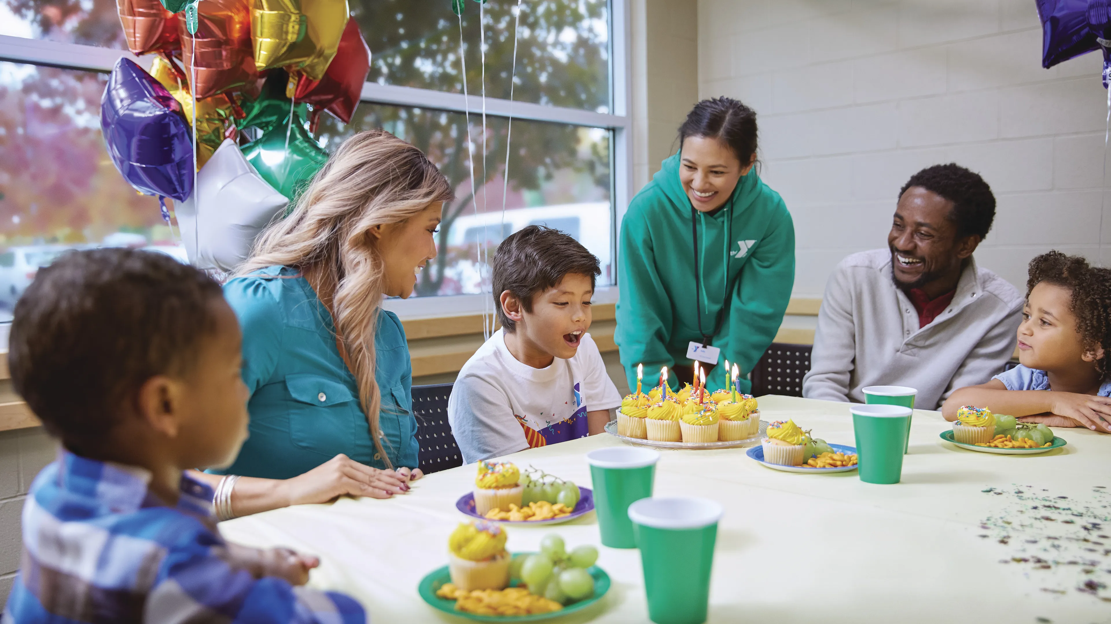 young boy blowing on birthday candles