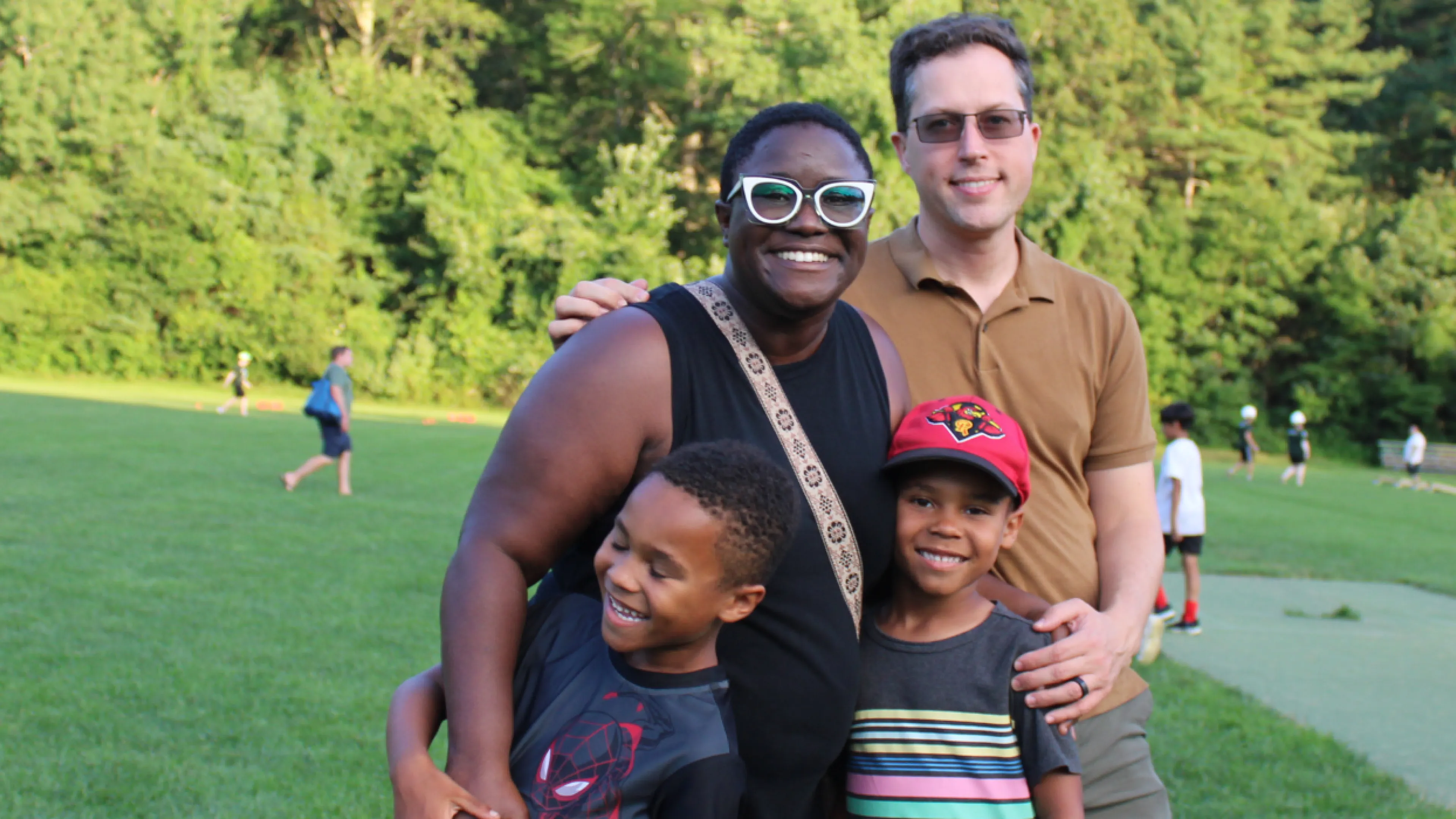 family of four smiling together