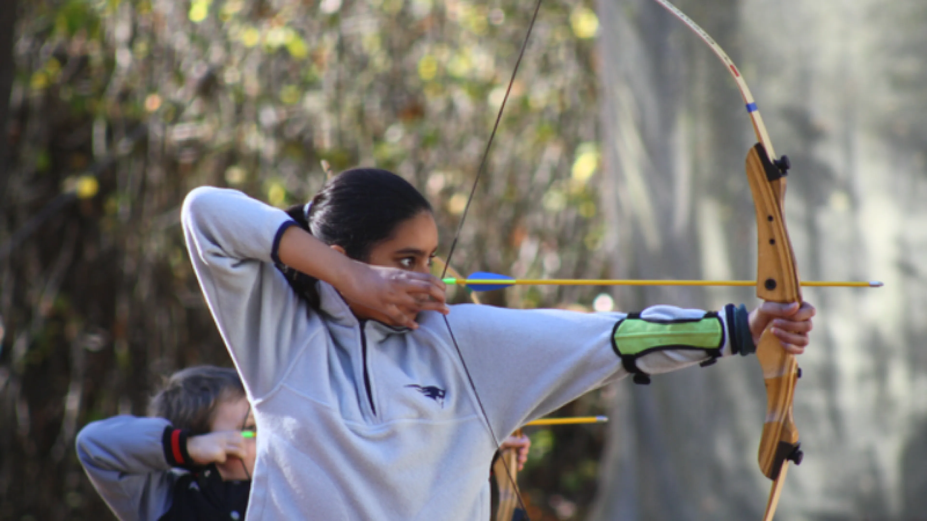 photo of a girl holding bow and arrow
