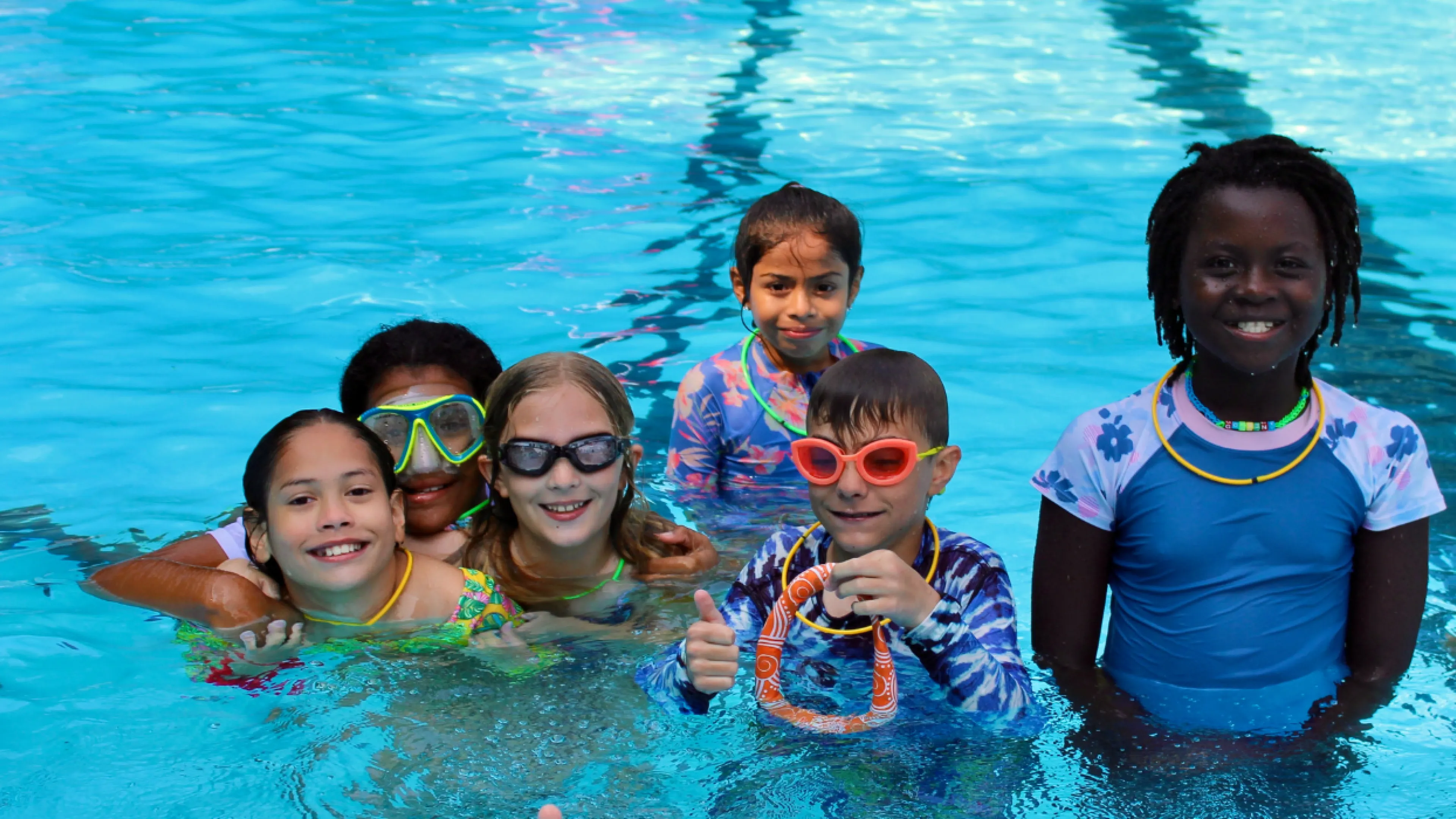group photo of campers in the pool