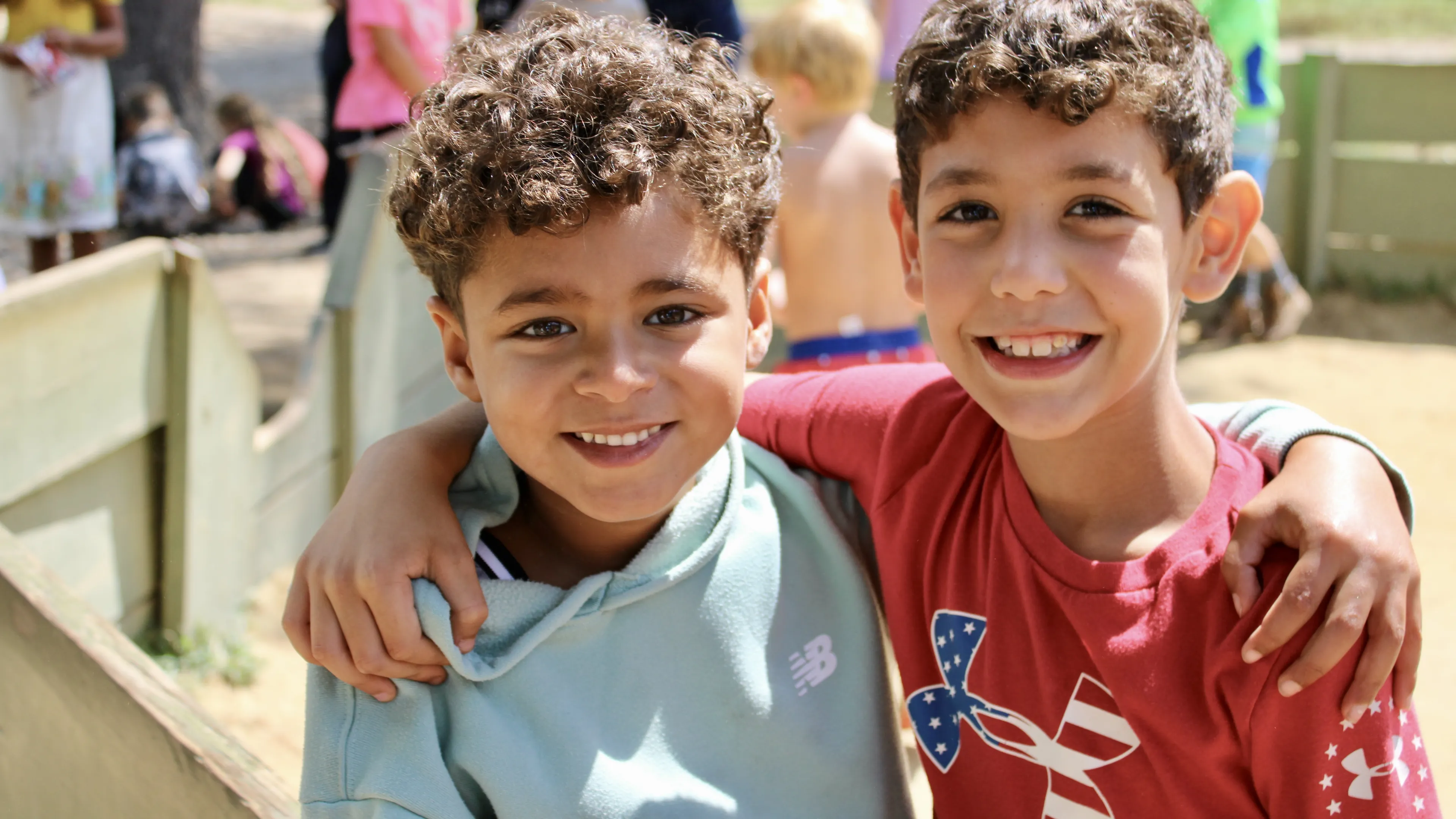 Smiling boys make friends at camp
