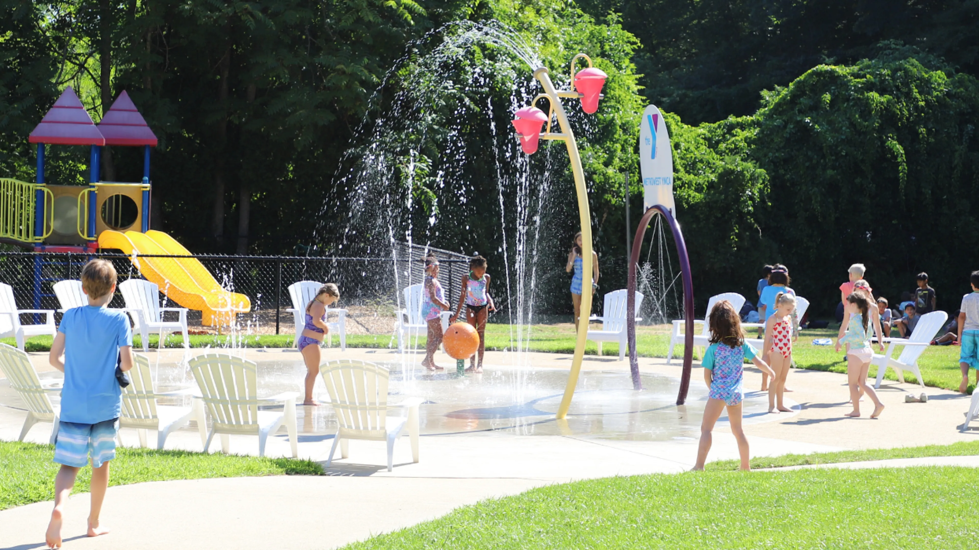 image of kids playing in a splash pad on a sunny day
