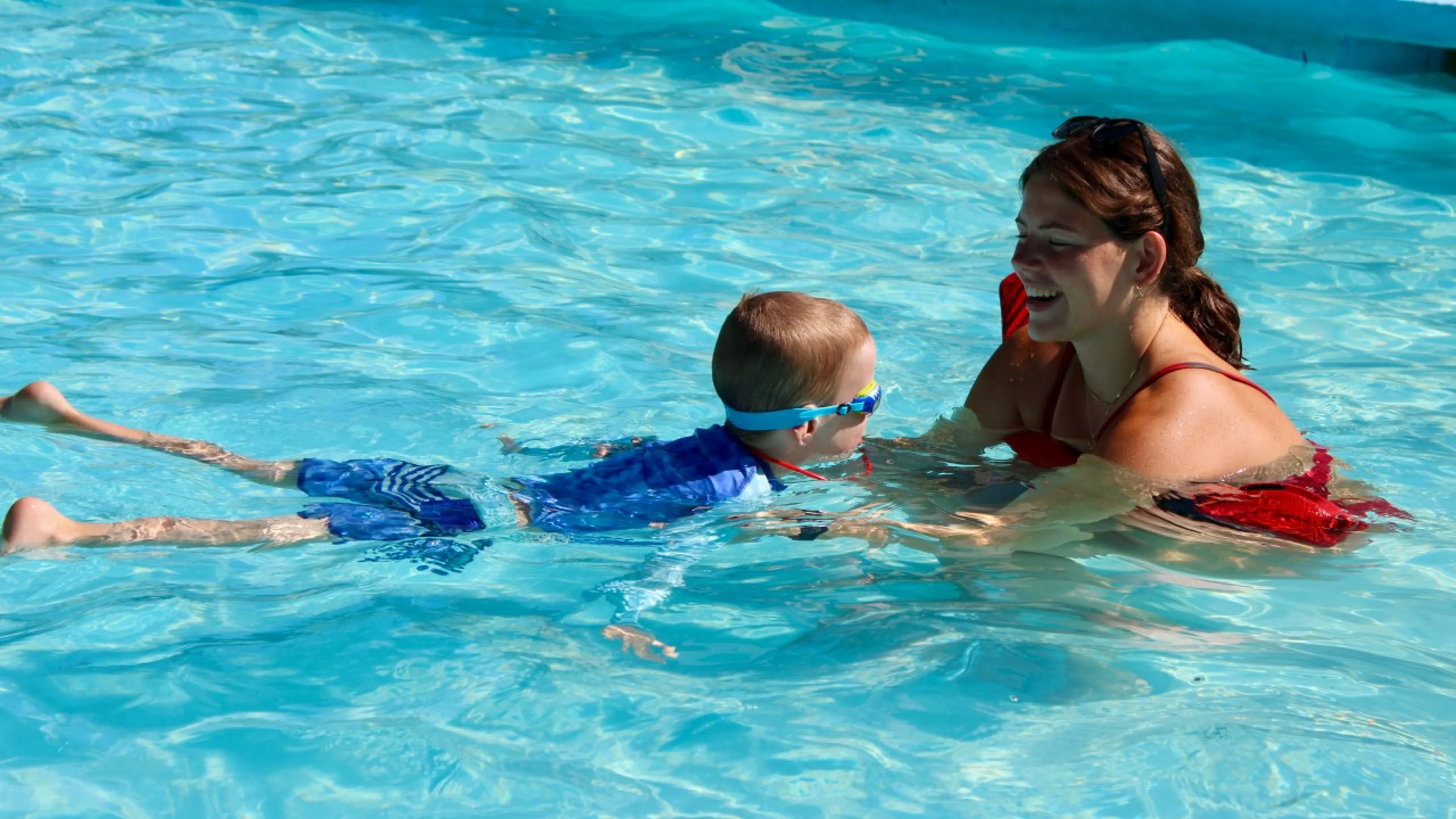 Instructor teaches a swim lesson in a YMCA pool