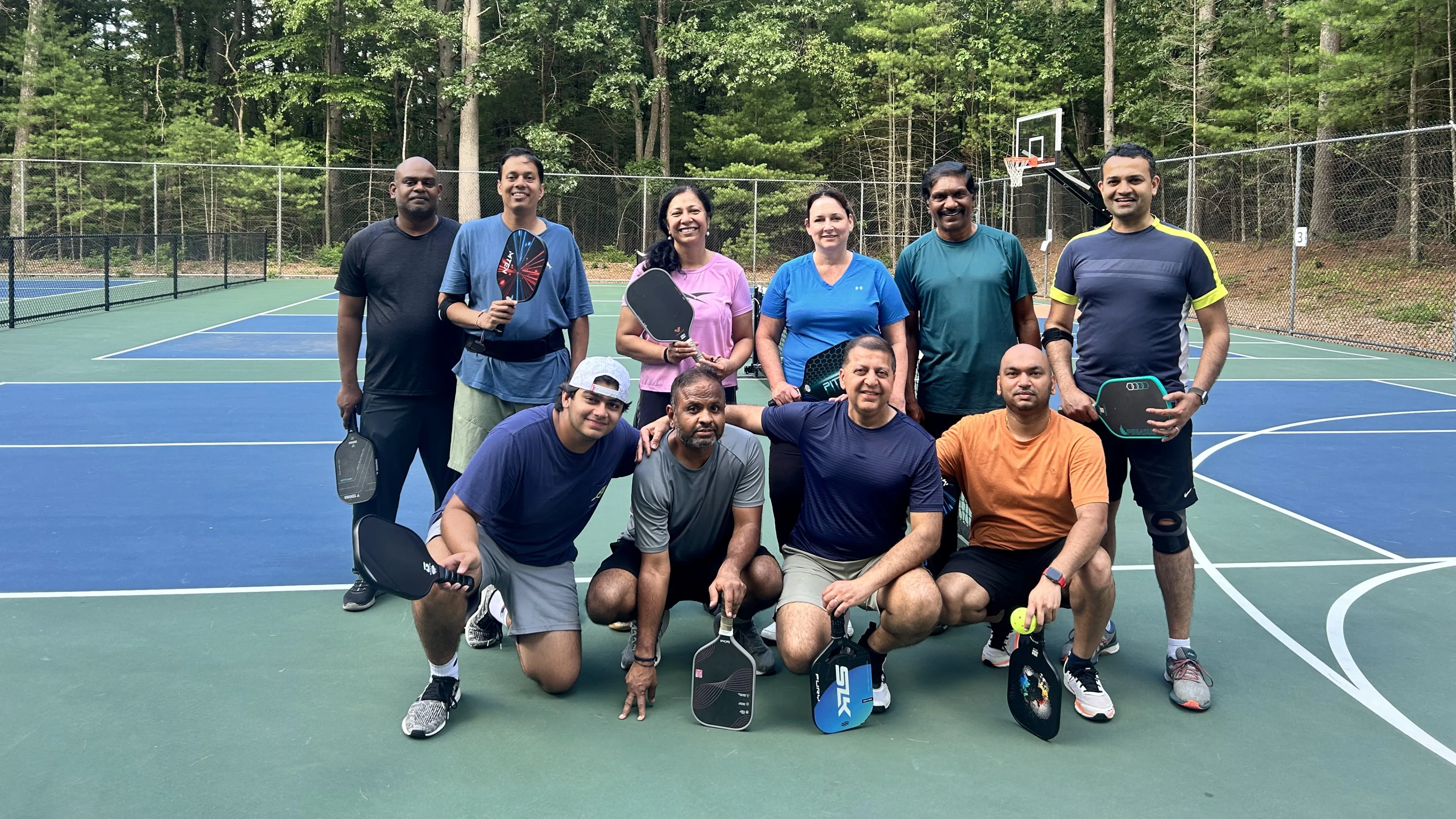 neighbors play pickleball on our outdoor courts