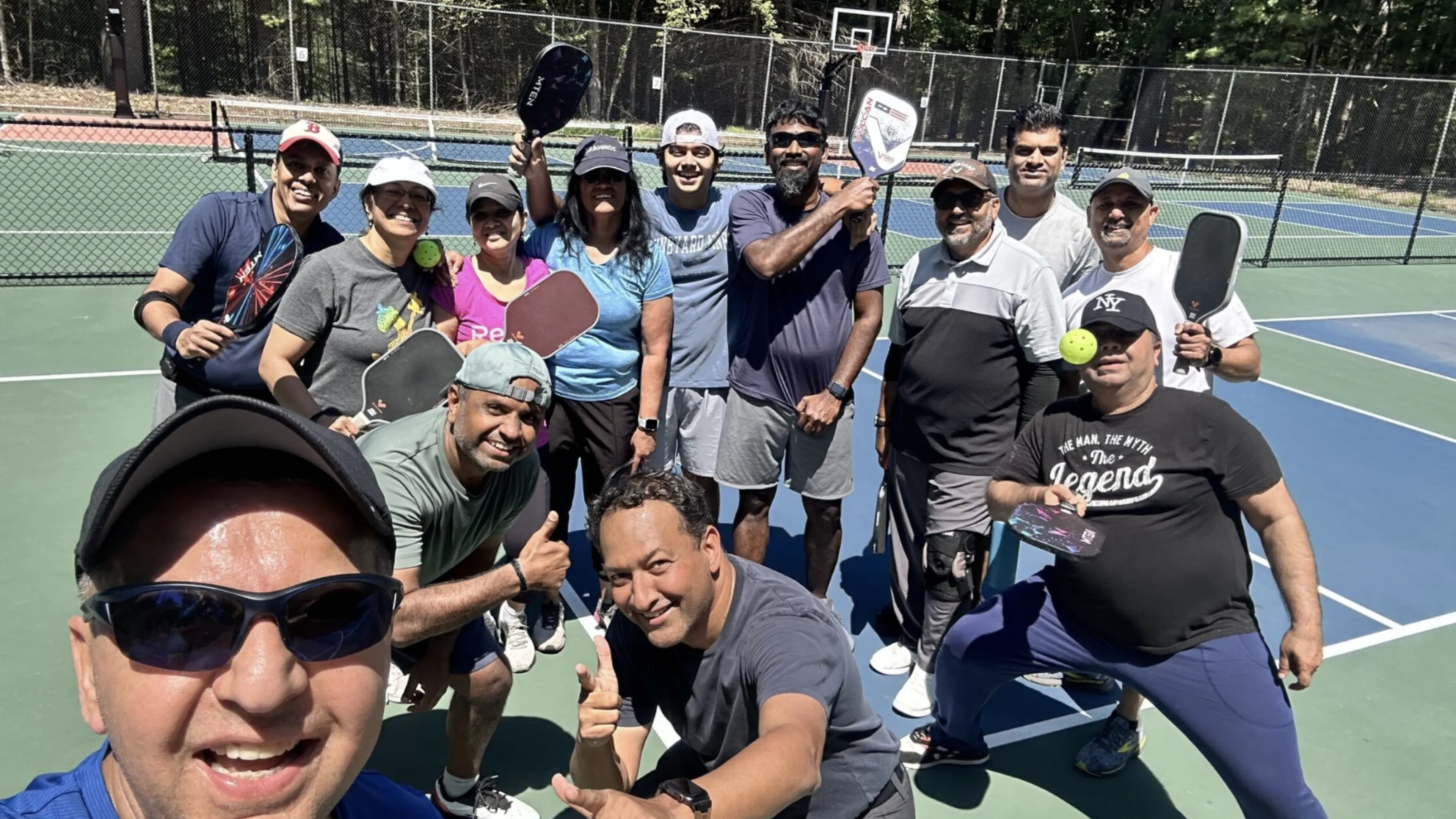 Men and women goofing around at a pickleball clinic