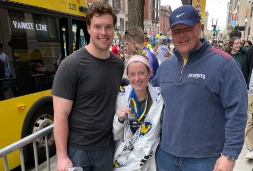 photo of a group of three smiling at the boston marathon