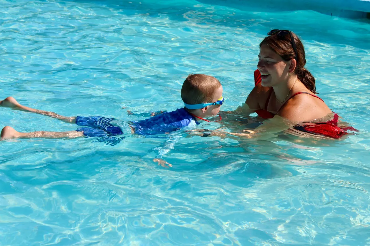 image of young swimmer and lifeguard in pool