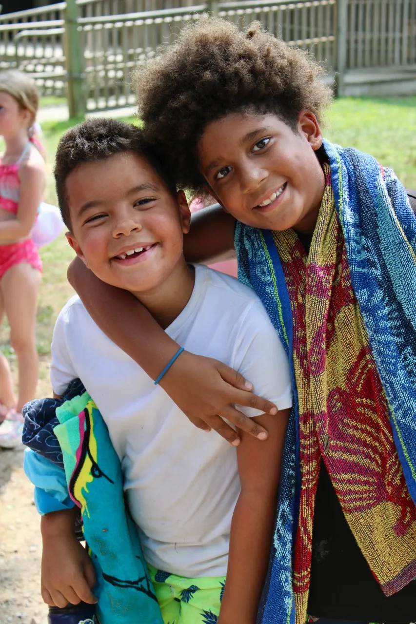 image of two young male campers smiling at the camera