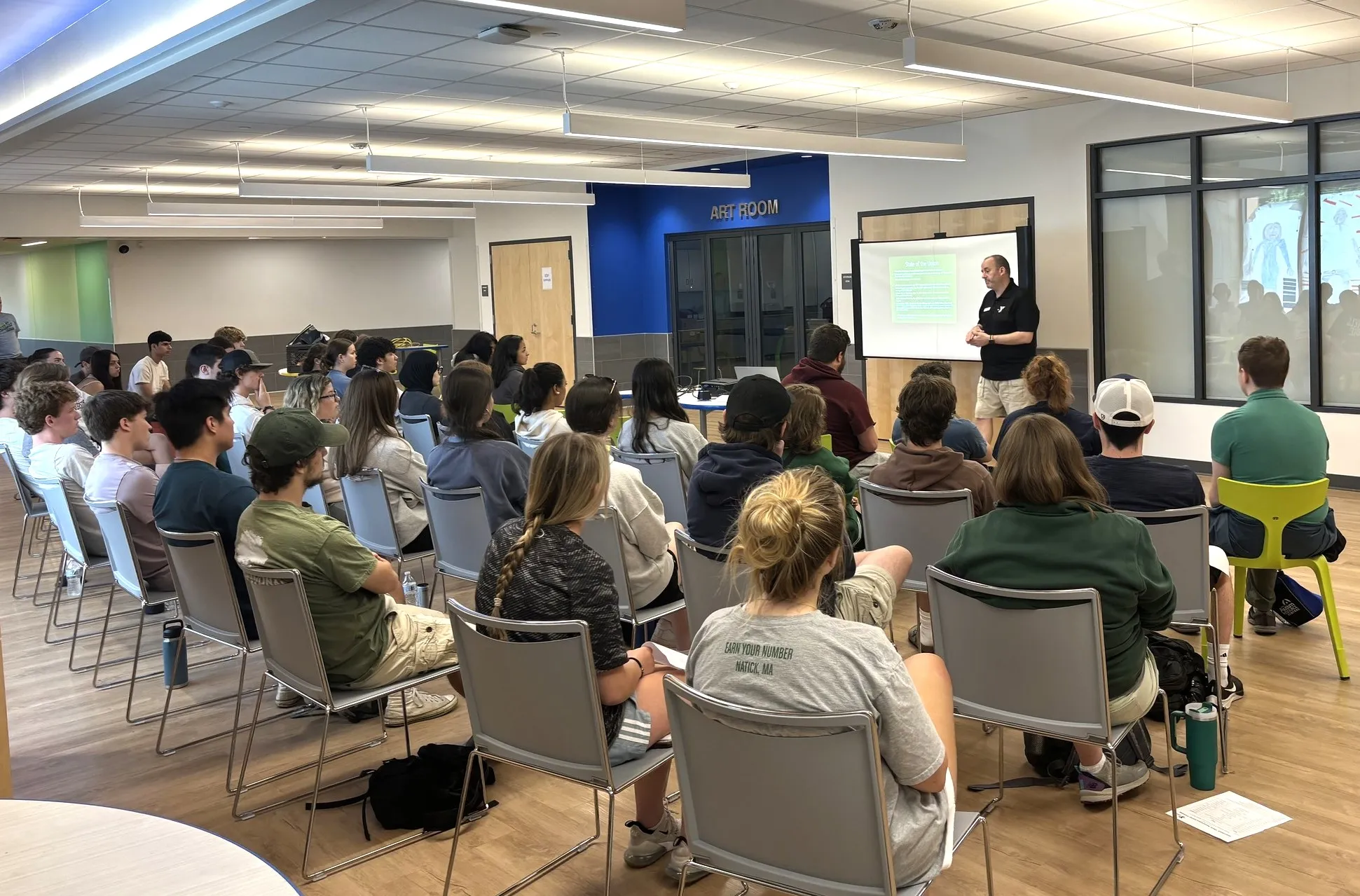 image of a group of people sitting down for a presentation