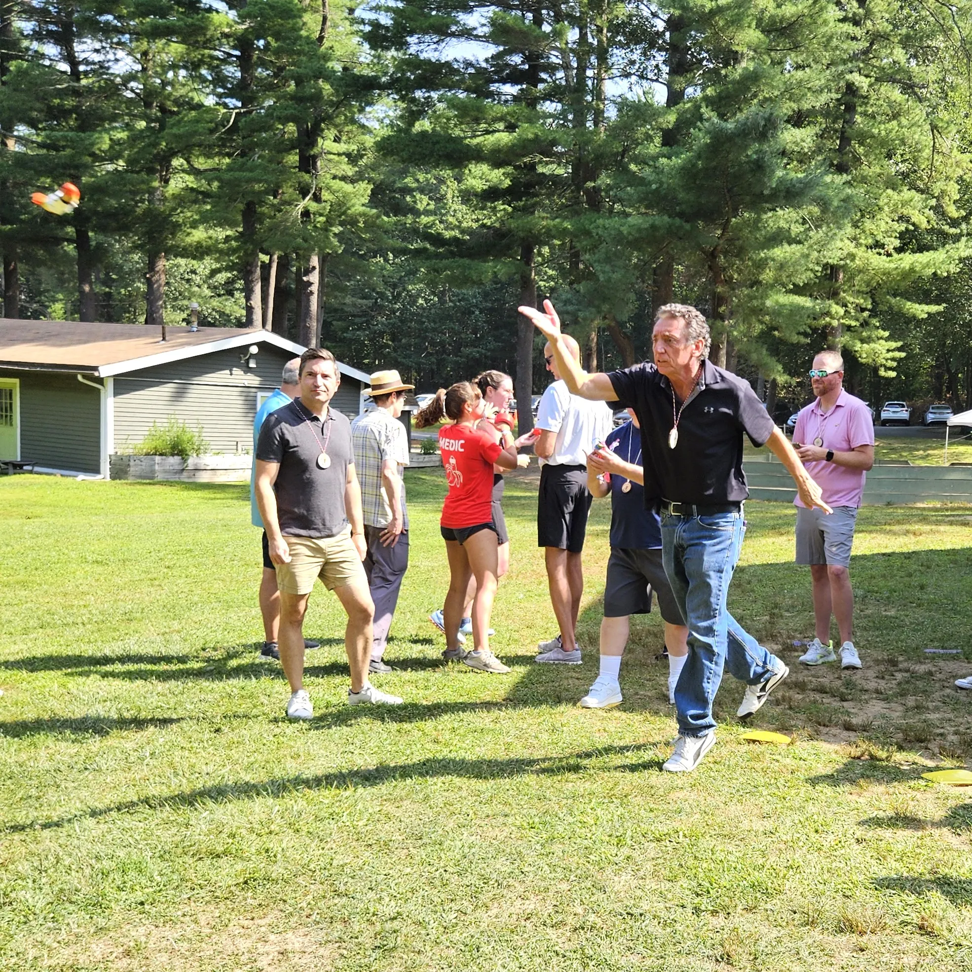 man participating in outdoor yard games on a sunny day