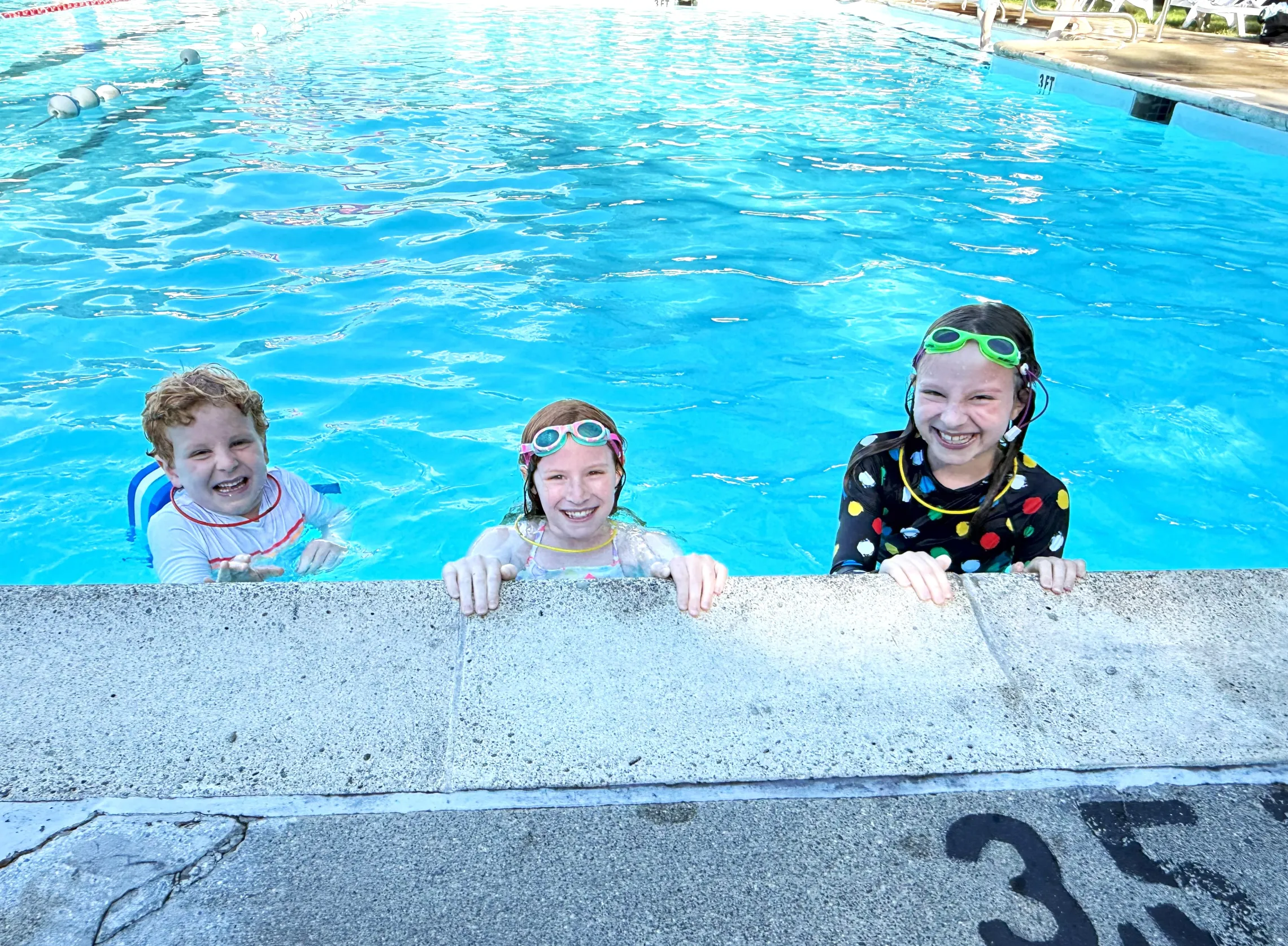 three kids in swimming pool