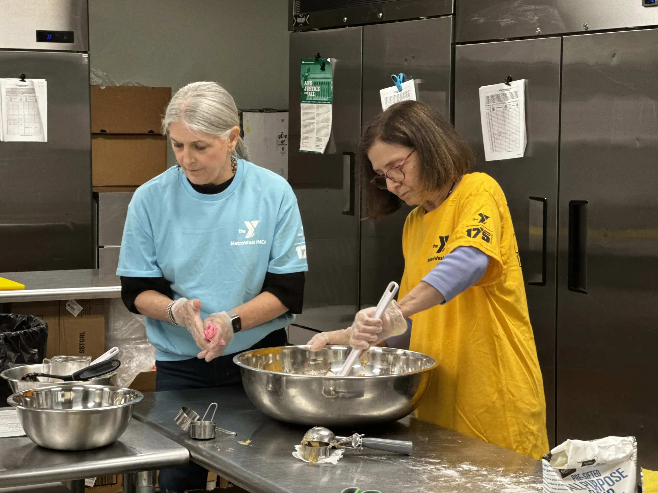 Volunteers make fresh apple muffins for campers