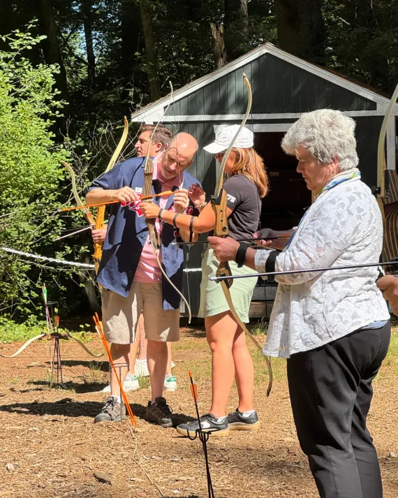 Metro West YMCA Outdoor Center associate director aids community leaders in archery on Advocacy Day