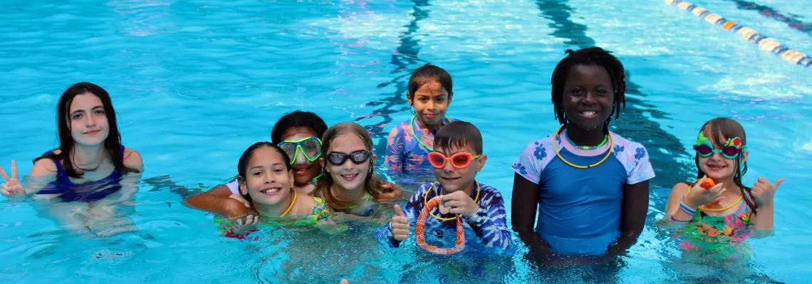 group photo of campers in the pool