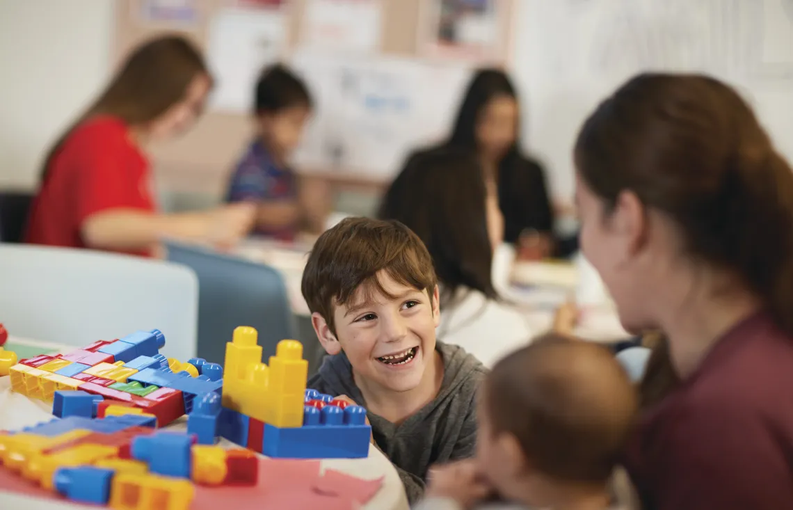 image of young boy smiling at his mom