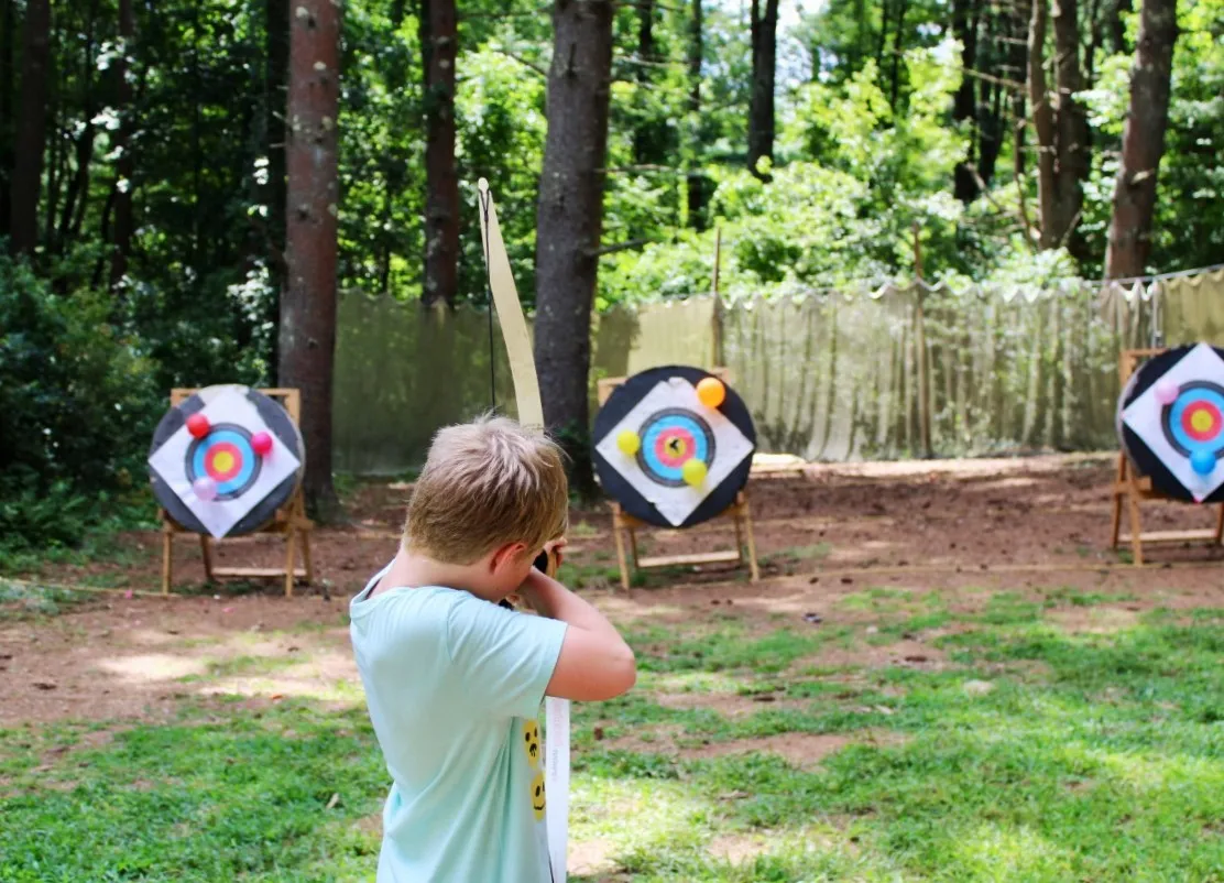 boy at outdoor archery range